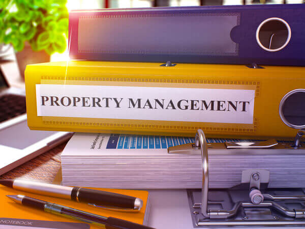 yellow binder holding property management certification course materials