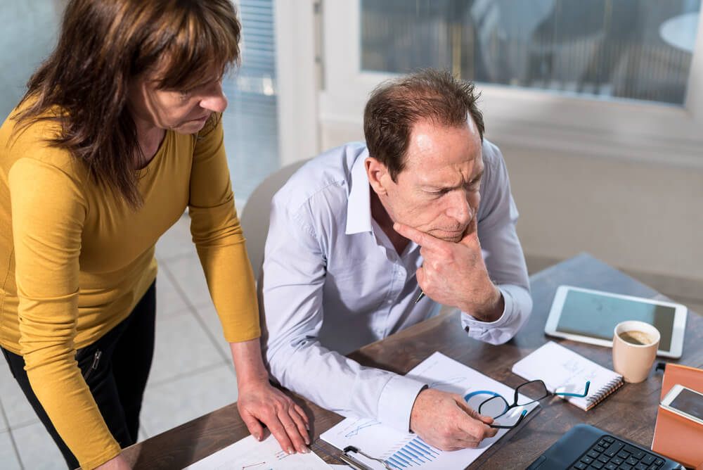 Female property manager working with a property owner at a desk